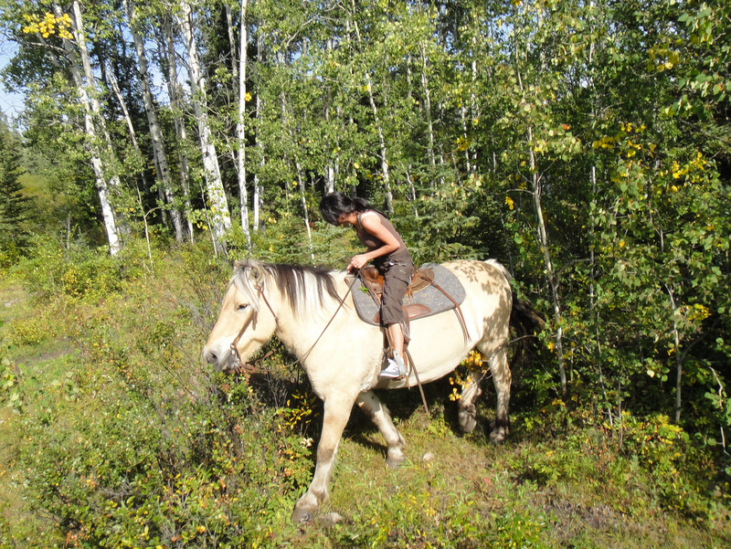 Rachna and her horse Homer emerging from the trees