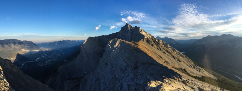 From Ha Ling Peak: Mountain peaks all around and Canmore down below
