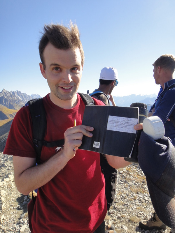 Signing the notebook. That hair is wild!